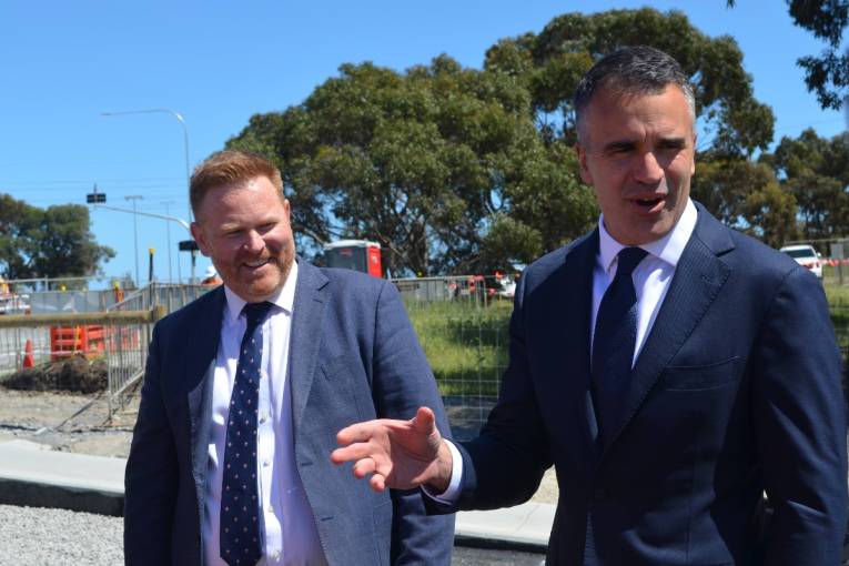 Alex Dighton and Peter Malinauskas speaking to construction workers at the Majors Road construction project.