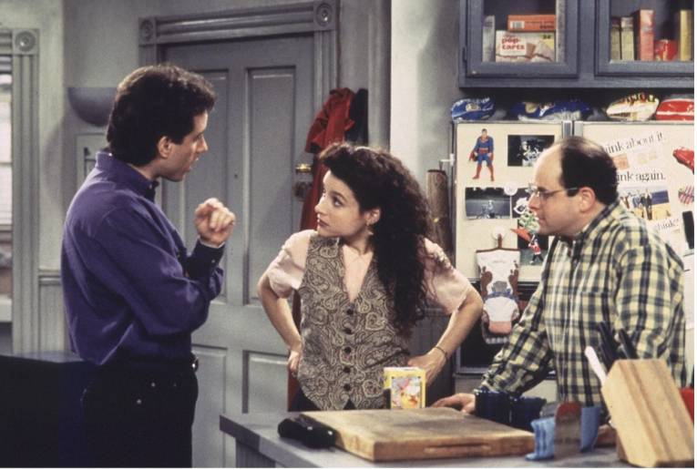 A still from the television show Seinfeld, with characters Jerry Seinfeld, Elaine Benes and George Costanza standing in Jerry's kitchen. 