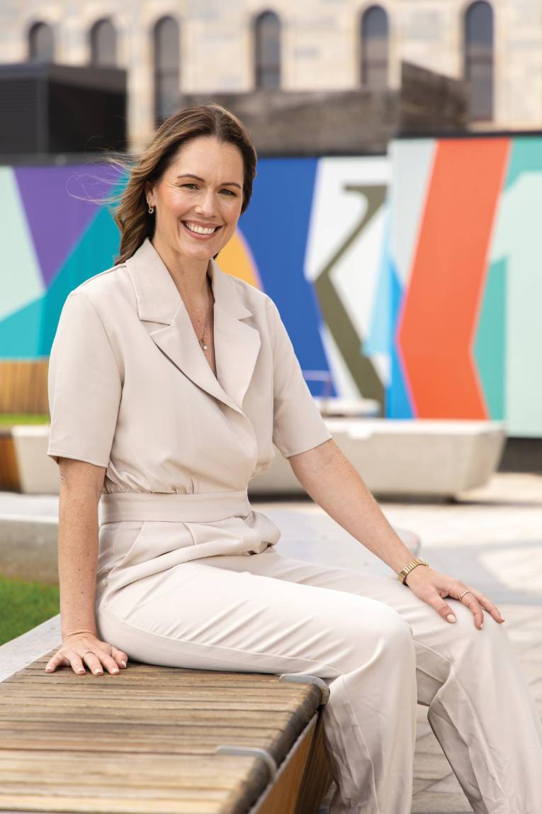 Photograph of a person sitting in a plaza