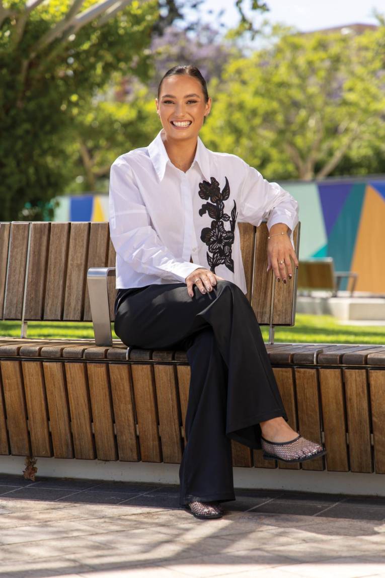 Photo of a person sitting in a plaza