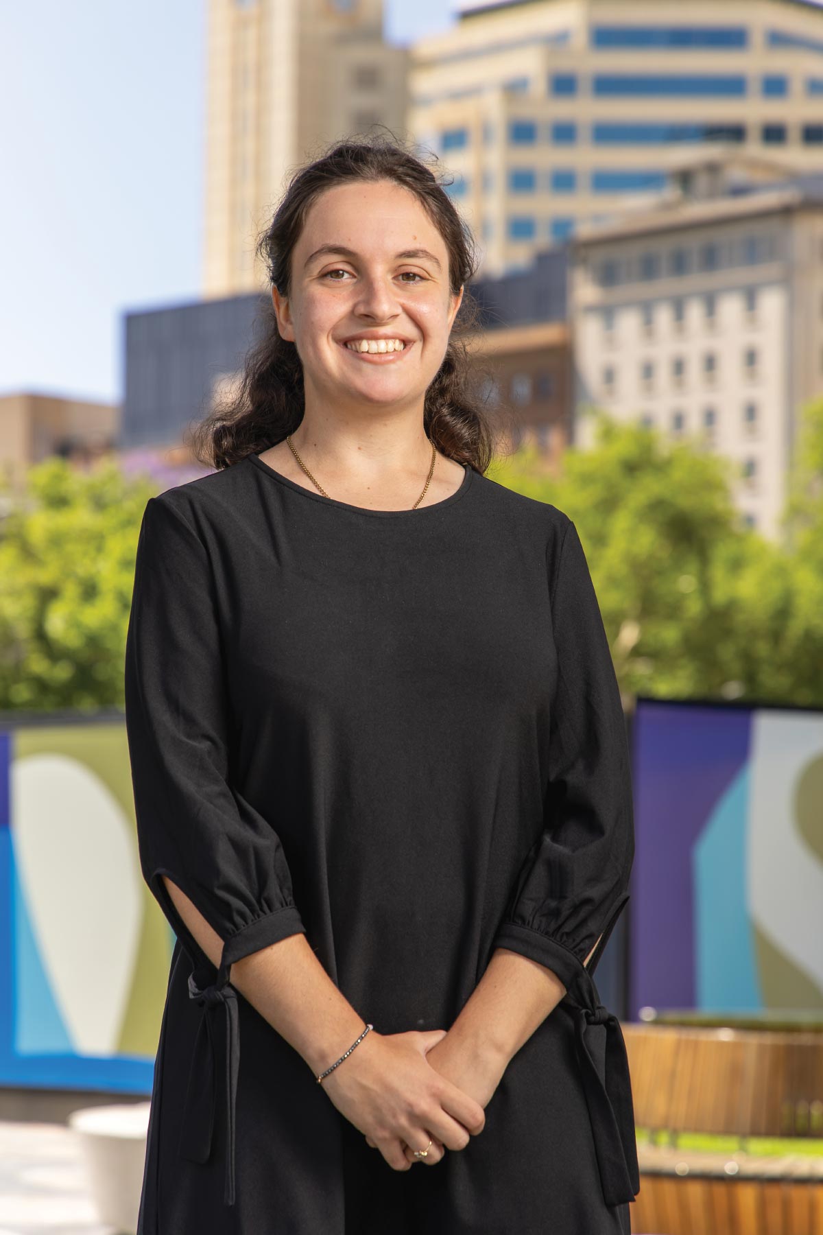 Photo of a person standing in a plaza