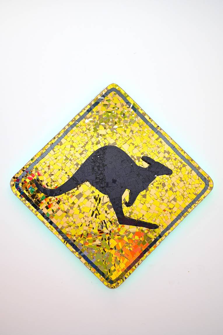 Artwork by Paul Yore, Sign (Kangaroo), 2025, mixed media assemblage on board comprising plastic, glass, fabric, trim, cotton thread, LED light, wood, synthetic polymer, adhesive, and fixtures, 174 x 174 x 13 cm