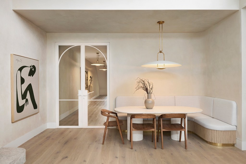 Alisa used booth seating in her dining area to save space. The Ralph Lauren light sits atop a table Alisa imported, and dining chairs from Satara.