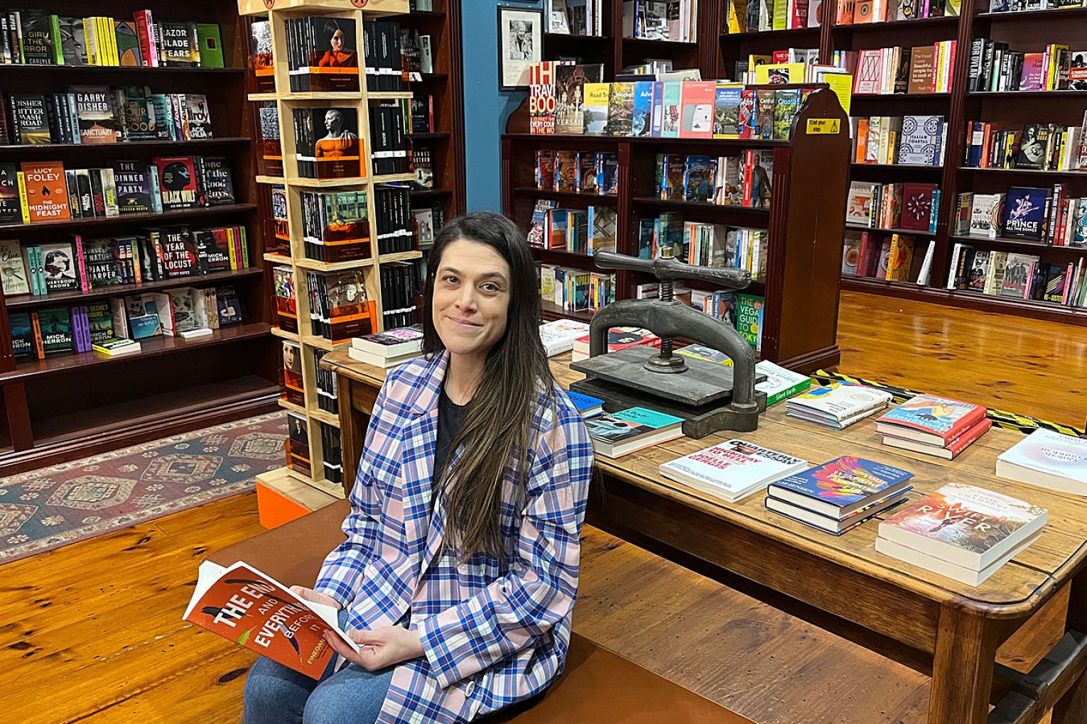 Imprints' new owner, Amelia Eitel, with Adelaide writer Finegan Kruckemeyer's new book 'The End and Everything Before It', which is currently being read by members of the shop's book club. Photo: Suzie Keen / InReview