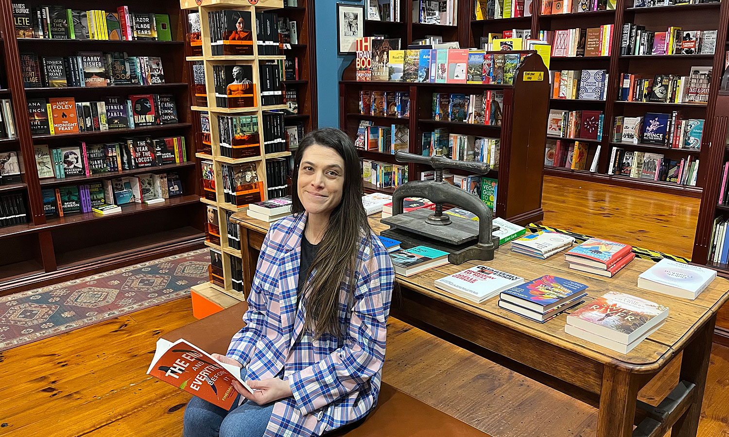 Imprints' new owner, Amelia Eitel, with Adelaide writer Finegan Kruckemeyer's new book 'The End and Everything Before It', which is currently being read by members of the shop's book club. Photo: Suzie Keen / InReview