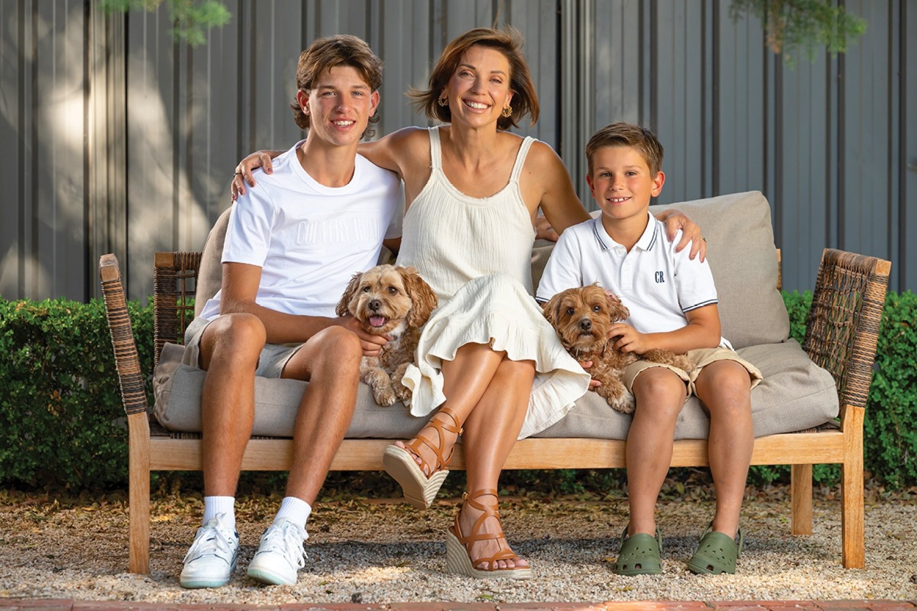 Anna relaxing at home with sons Ollie and Sebastian and dogs Toby and Elliott.