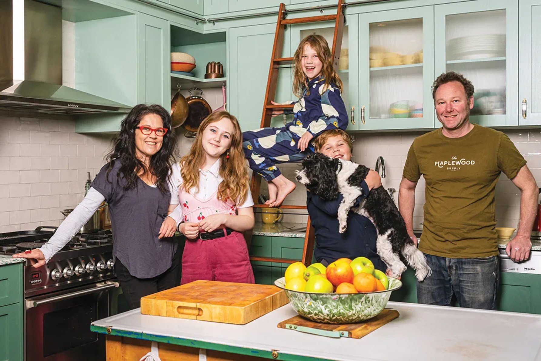 Annabel, Jeremy and the kids in the family kitchen of their previous home where Annabel filmed much of Kitchen Cabinet