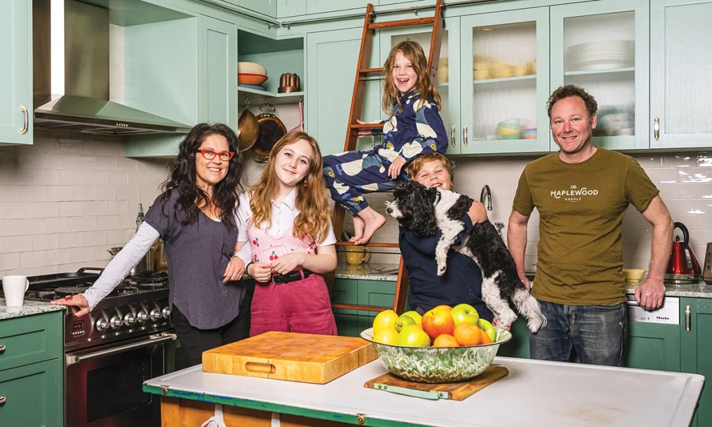 Annabel, Jeremy and the kids in the family kitchen of their previous home where Annabel filmed much of Kitchen Cabinet