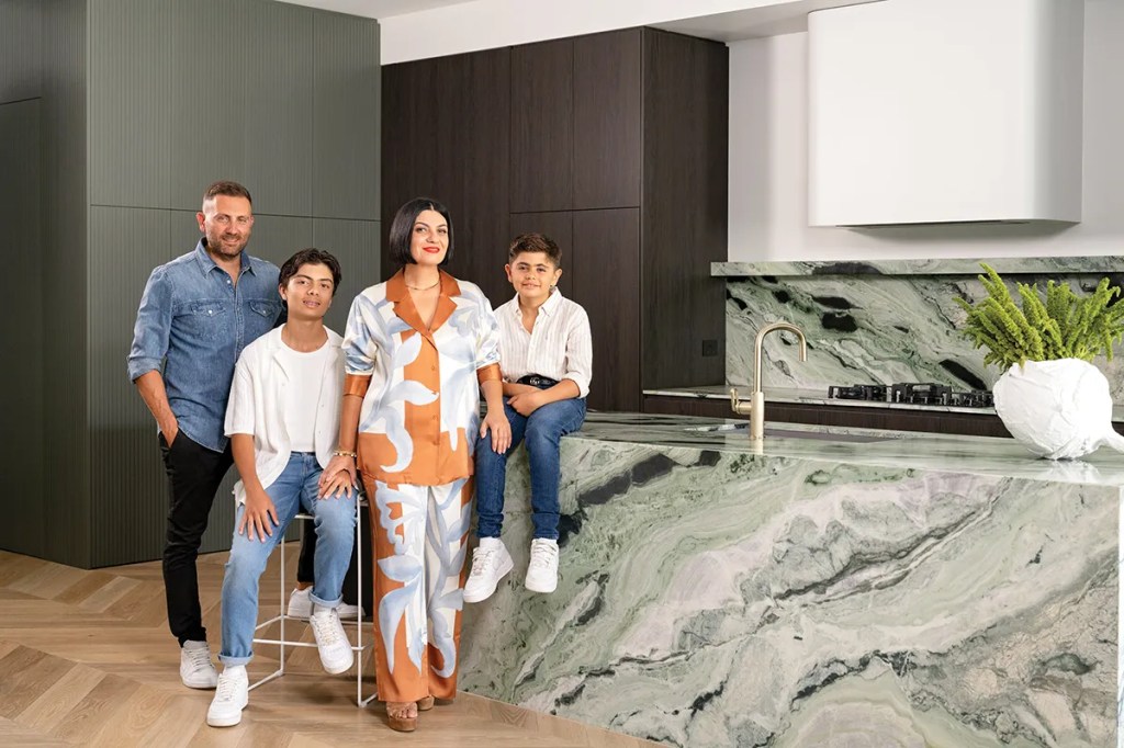 Nic, Jacob, Mirella (wearing Sir The Label) and Santiago in their beautiful kitchen. Stools by Adelaide firm Agostino and Brown and white vessel from Floristry by Sally Wotton.