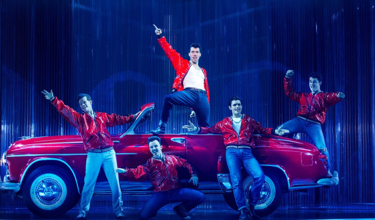 Fabian Andrés as Danny, Keanu Gonzalez as Kenickie and the Adelaide 2024 cast of Grease The Musical. Photo: Naomi Jellicoe