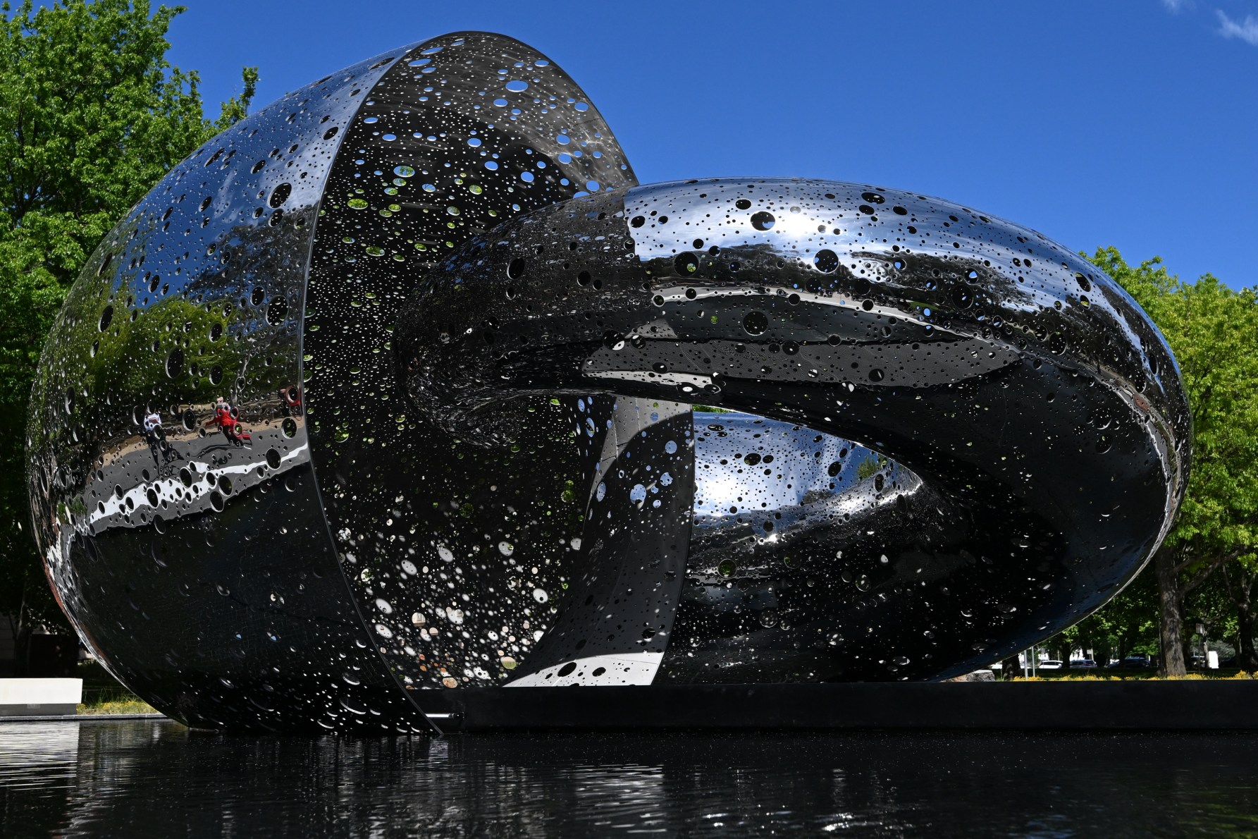 The Ouroboros sculpture is seen during the official unveiling of Lindy Lee's Ouroboros at the National Gallery of Australia in Canberra, Thursday, October 24, 2024. (AAP Image/Lukas Coch) NO ARCHIVING