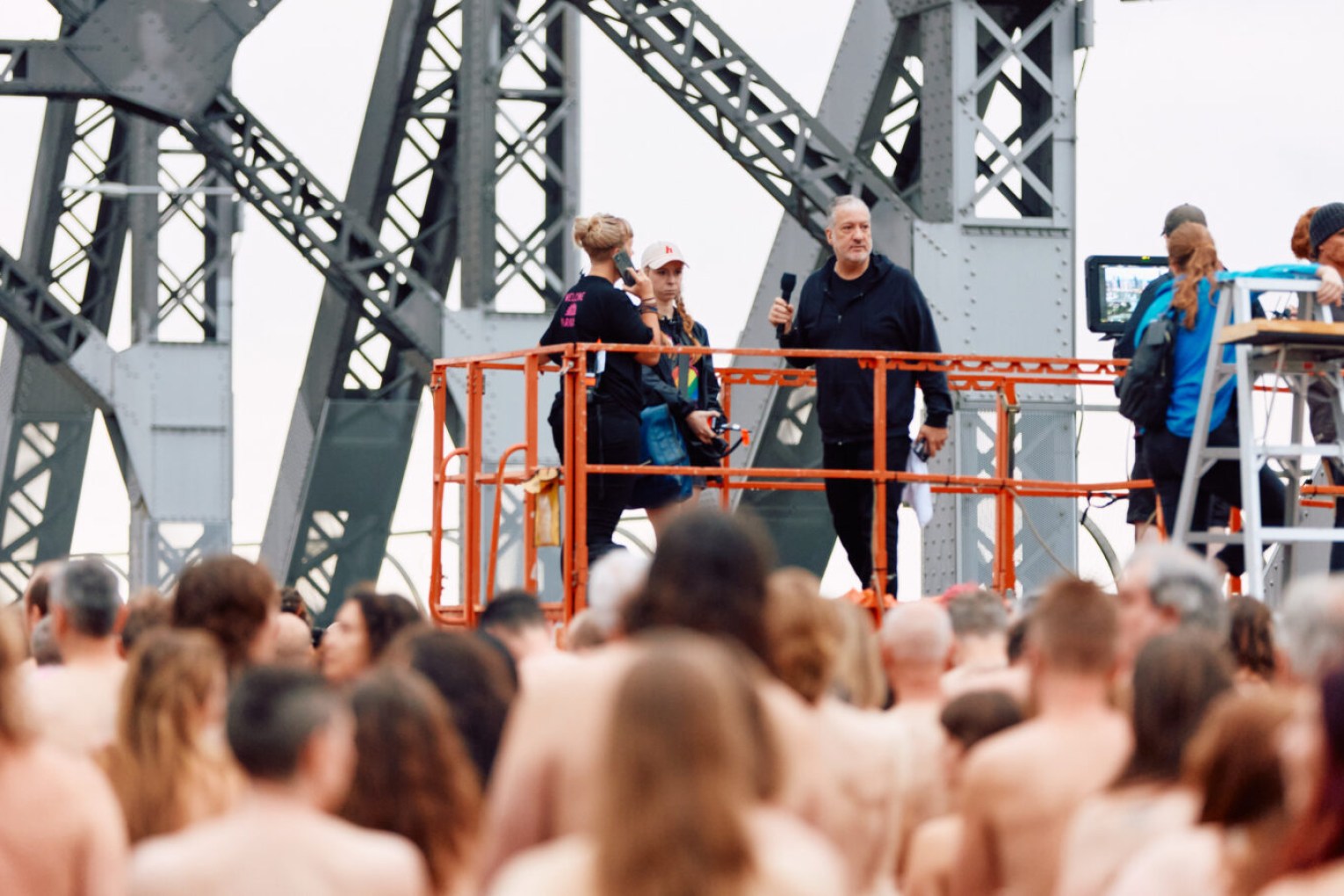 Spencer Tunick directs his latest mass nude photo shoot on the Story Bridge on Sunday. October 27. Photo: Markus Ravik