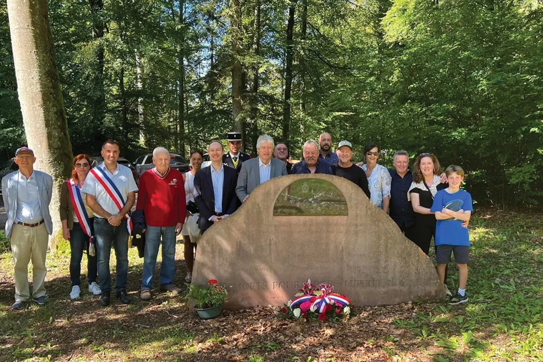 Journalist Genevieve Meegan, second from right, with her family and members of the Montbronn community who built this memorial to honour those who died here in WWII, including Genevieve's uncle John Wilkinson. 