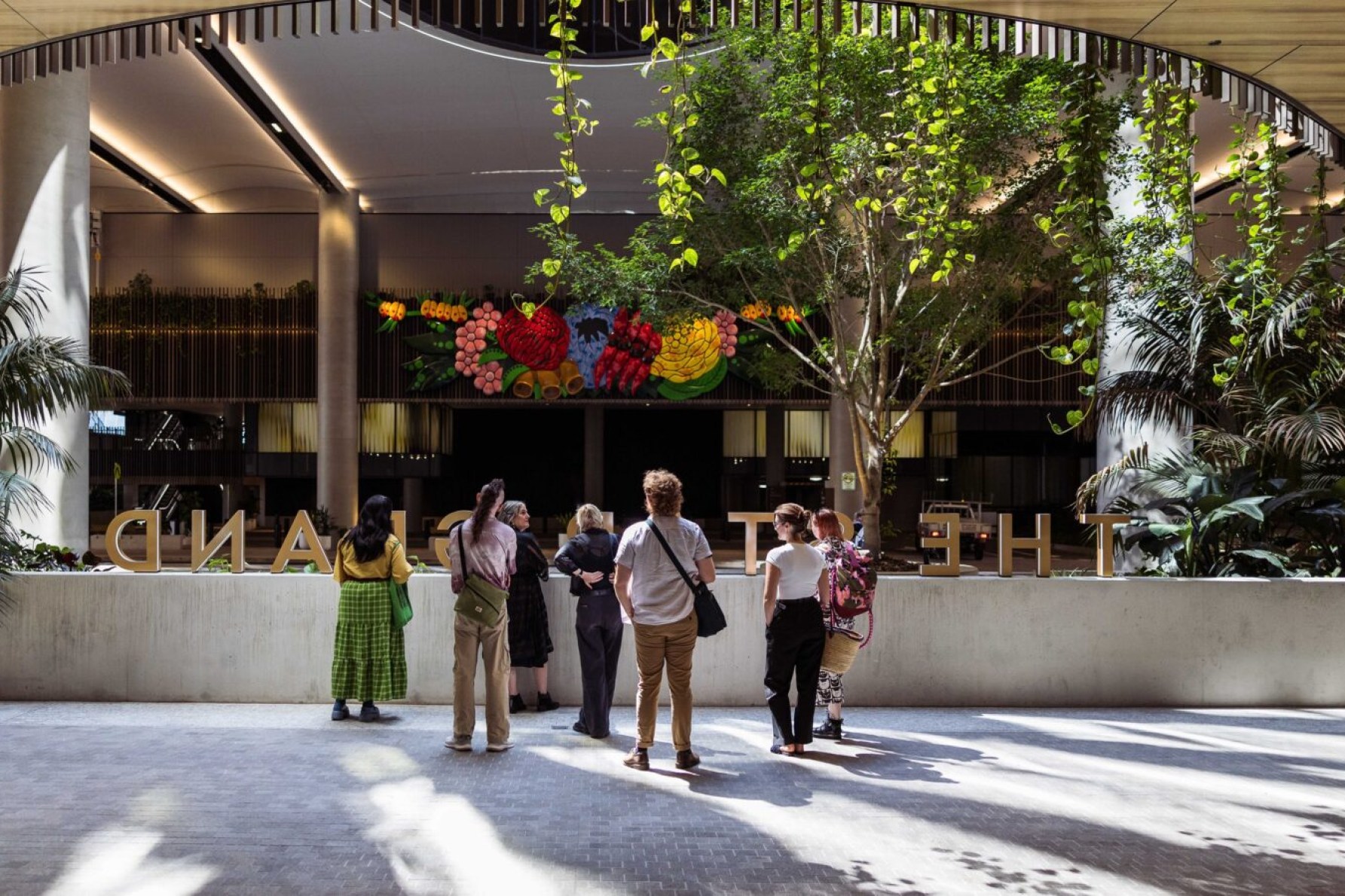 A walking tour of The Queen's Wharf Brisbane precinct takes in the magnficent and colourful large-scale work Inhabitant by Brisbane Indigenous artist Tony Albert.