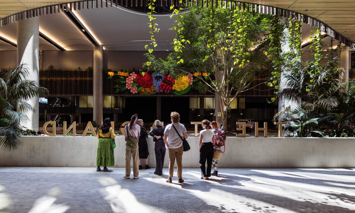 A walking tour of The Queen's Wharf Brisbane precinct takes in the magnficent and colourful large-scale work Inhabitant by Brisbane Indigenous artist Tony Albert.