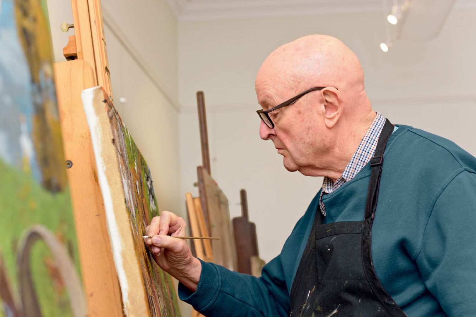 William Robinson at work - the artist's paintings have inspired a fusion of ballet and music in Soiree, showcasing dancers from the Queensland Ballet Academy.
