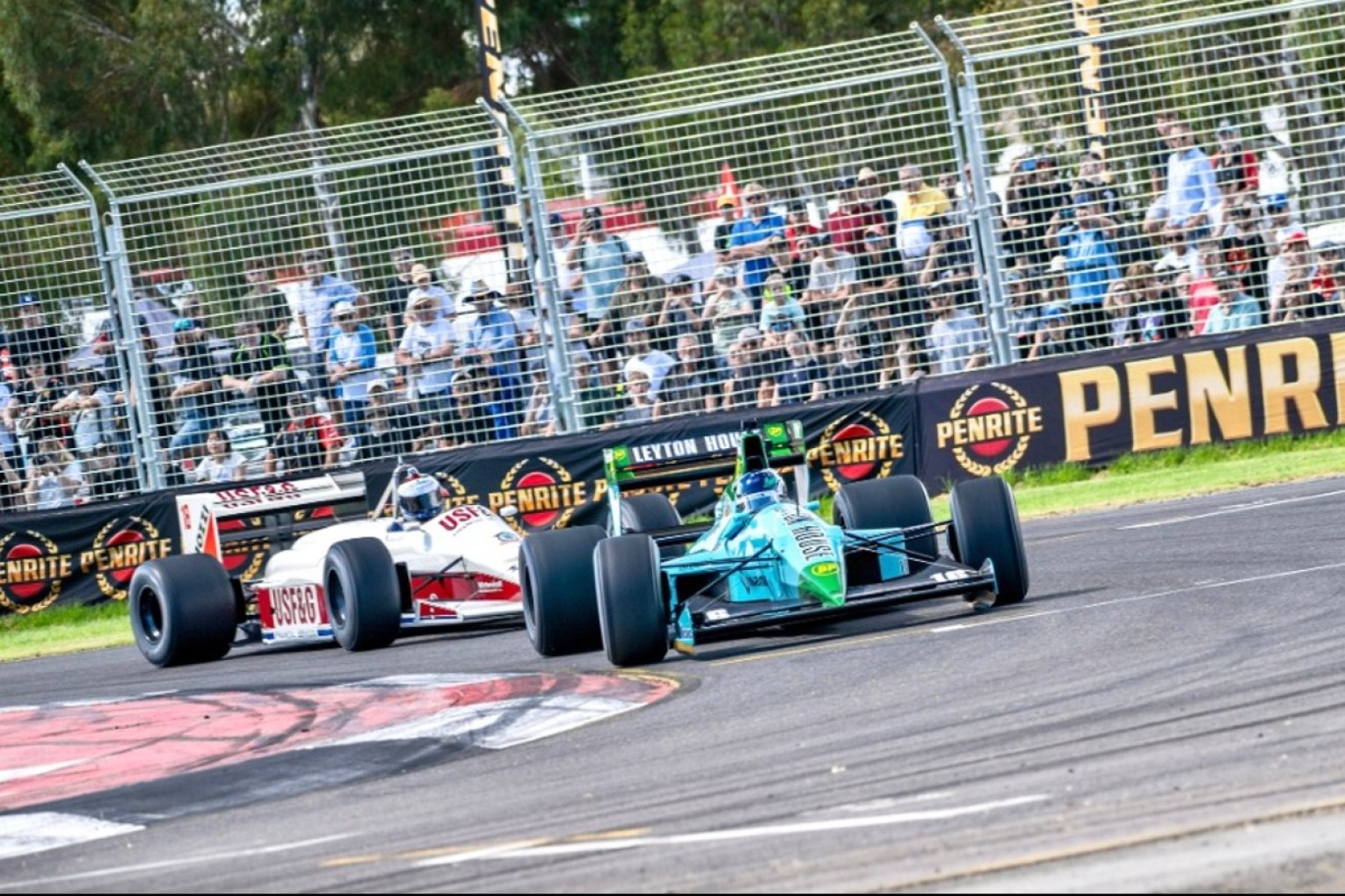 Formula 1 driver Valtteri Bottas (front) and Australian motorsport legend Craig Lowndes on track at the 2024 Adelaide Motorsport Festival in cars that raced in the Adelaide Grand Prix during the 1980s.