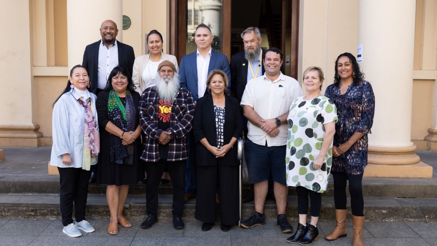 Deb Moyle (bottom row second from right) with members of the Central Voice. Top row (L-R) Tony Minniecon, April Lawrie, Robert Leidig, Scott Wilson. Bottom row:  Susan Dixon, Cheryl Axleby, Moogy Sumner, Rosalind Coleman, Douglas Clinch, Deb Moyle, Tahlia Wanganeen. Photo: First Nations Voice/supplied