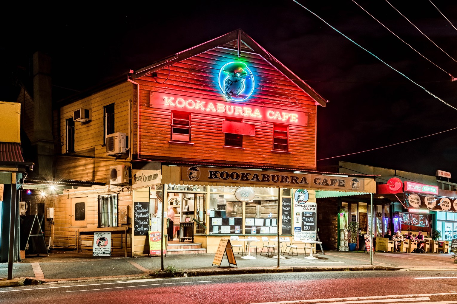 Kookaburra Cafe's neon sign lit up in Paddington, inner-Brisbane. Photo courtesy Blake Patrick, John Oxley Library, State Library of Queensland.