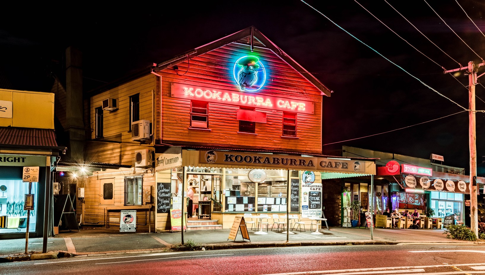 Kookaburra Cafe's neon sign lit up in Paddington, inner-Brisbane. Photo courtesy Blake Patrick, John Oxley Library, State Library of Queensland.