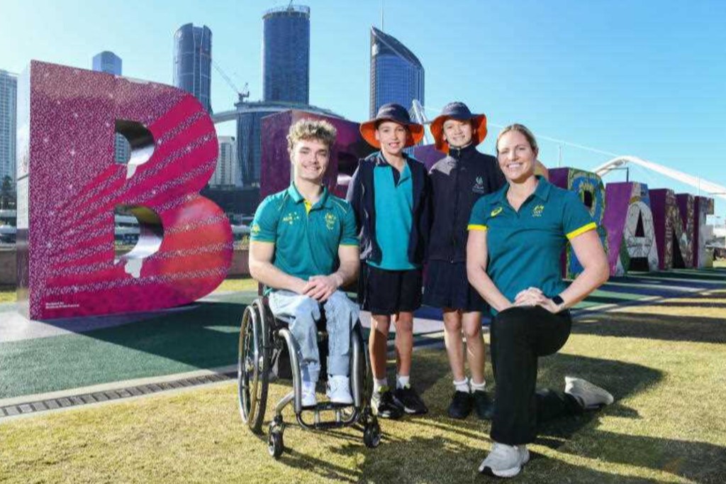 Queensland's new government claims its predecessor has not allocated funding for athlete villages to house athletes like Eithen Leard and Emily Seebohm seen here celebrating the eight year milestone. Photo: AAP Image/Jono Searle