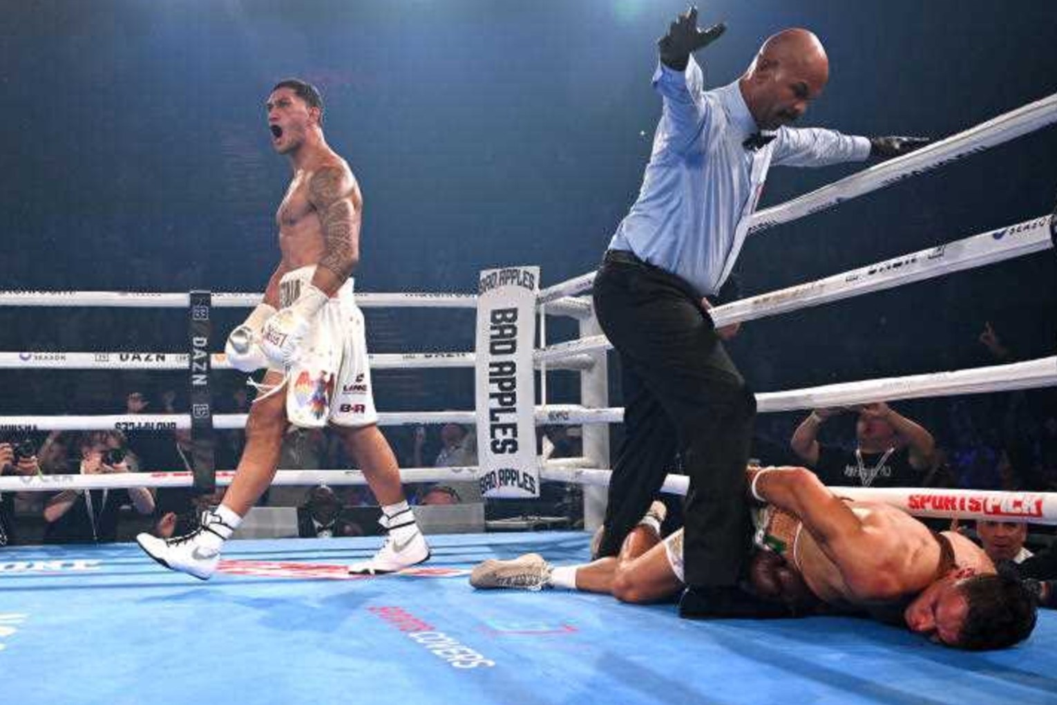 Jai Opetaia walks away in triumph after knocking out New Zealand's David Nyika in the fourth round. Photo: Dave Hunt/AAP