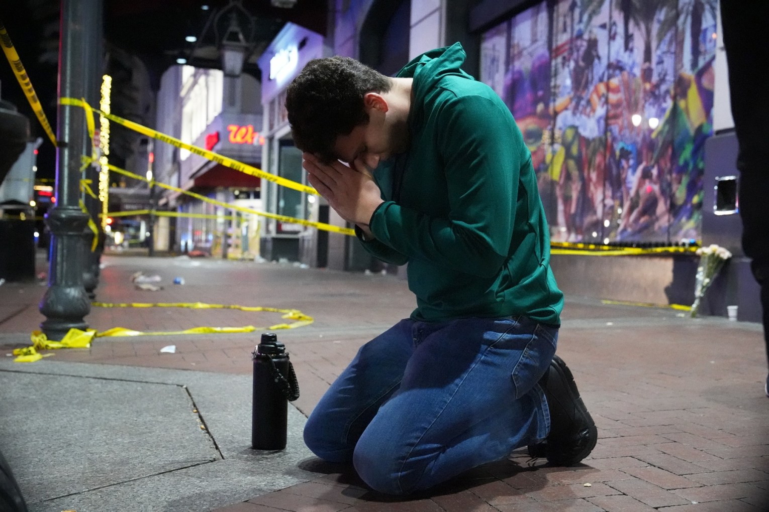 Matthias Hauswirth of New Orleans prays on the street near the scene where a vehicle drove into a crowd on New Orleans' Canal and Bourbon streets, Wednesday, Jan. 1, 2025. Photo: AP/George Walker