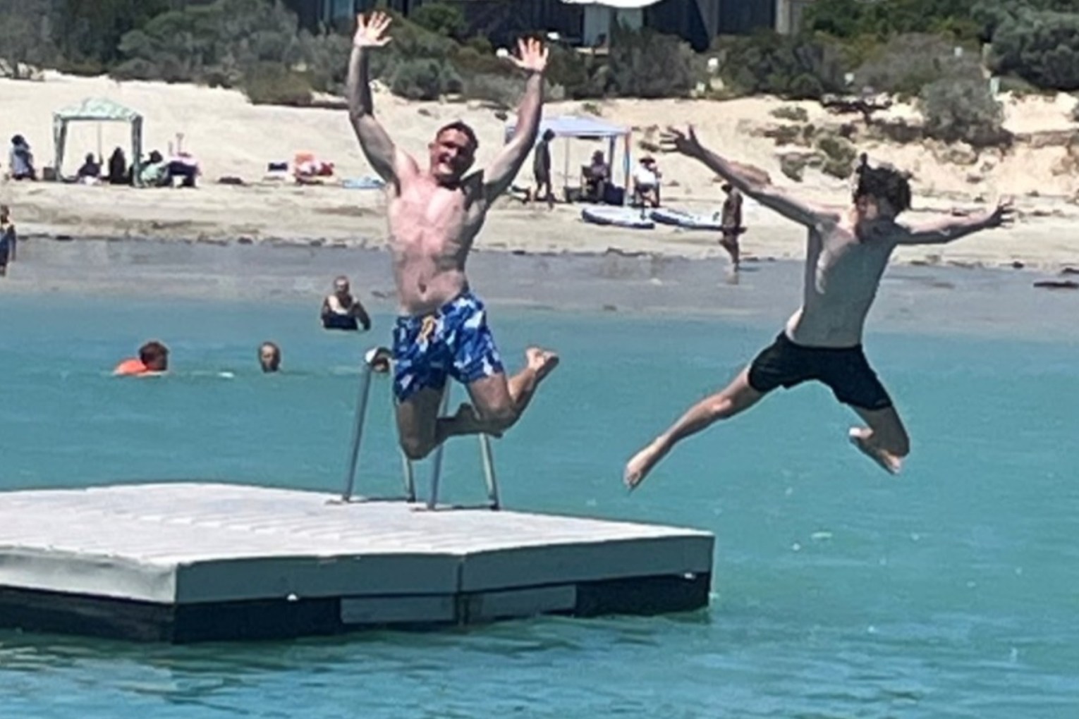 Lachlan Parker (left) and Oliver Knight (right) doing the first star jump off the pontoon. Photo: District Council of Robe/ Nat Treager