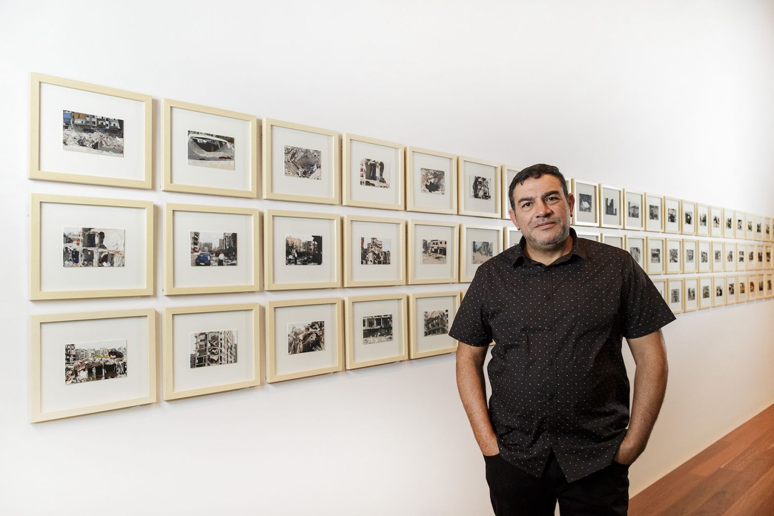 Khaled Sabsabi with his work featured in the 2018 Adelaide Biennial. Photo: Saul Steed / Supplied