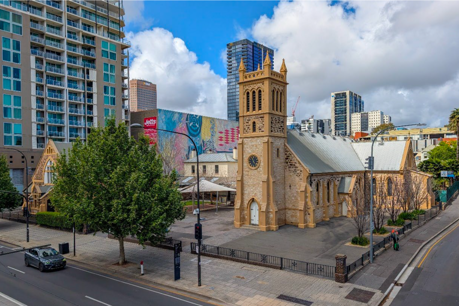The current Trinity Church site on the corner of Morphett Street and North Terrace. The tower proposed will be built in the current car park south of the church. 