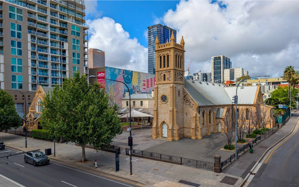 The current Trinity Church site on the corner of Morphett Street and North Terrace. The tower proposed will be built in the current car park south of the church. 