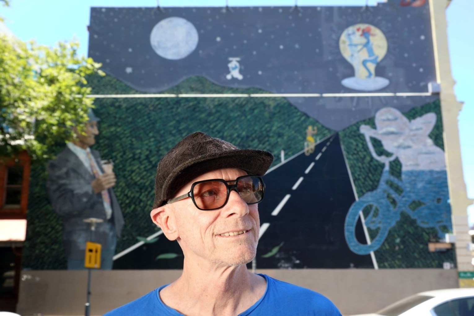 Adelaide artist Driller Jet Armstrong with his iconic Alien from E-Street Saturn mural on the corner of Frome and Rundle streets. Photo: Tony Lewis / InDaily