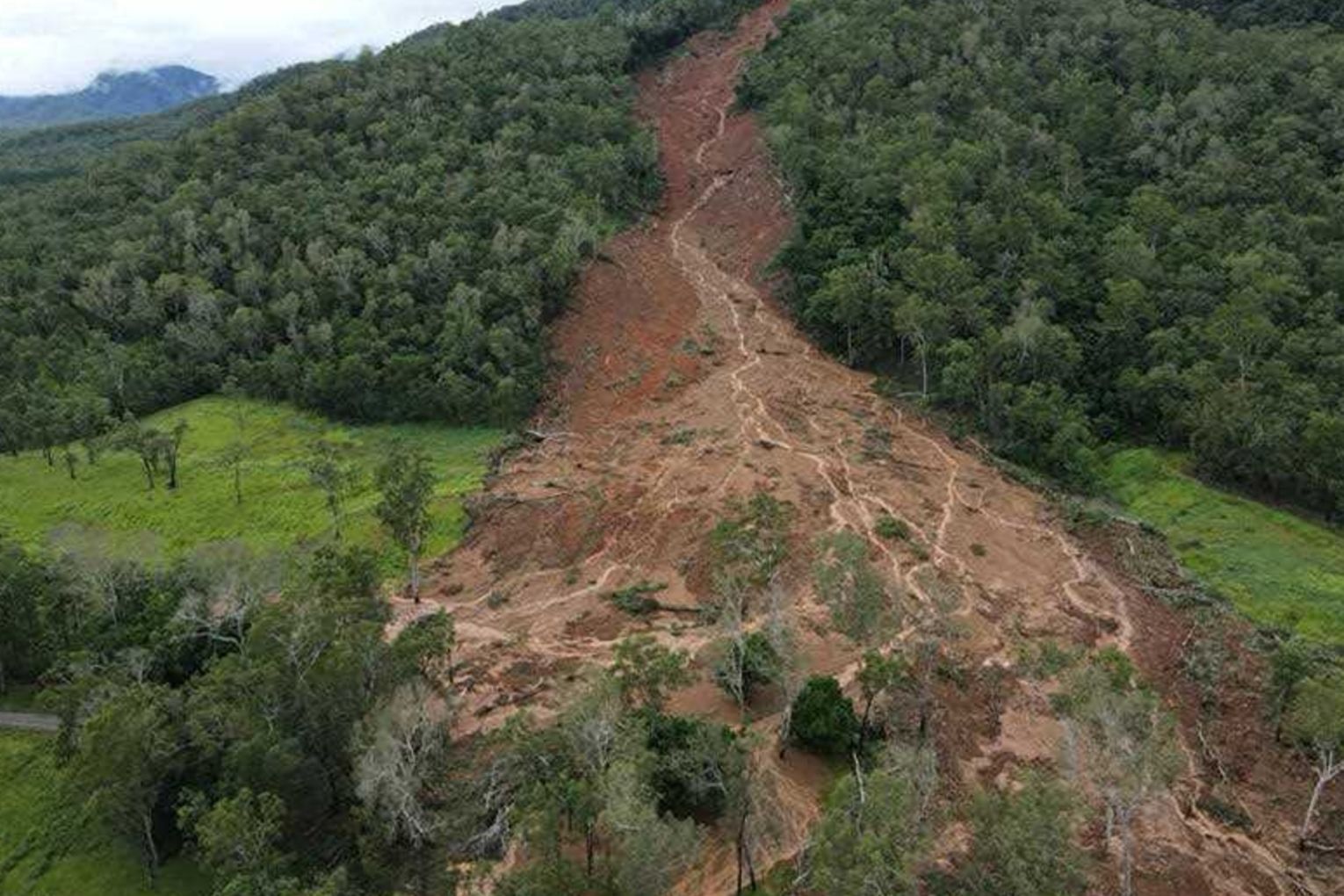 A family were lucky to escape a massive landslide, triggered by heavy rain. Photo: Aaron Pike