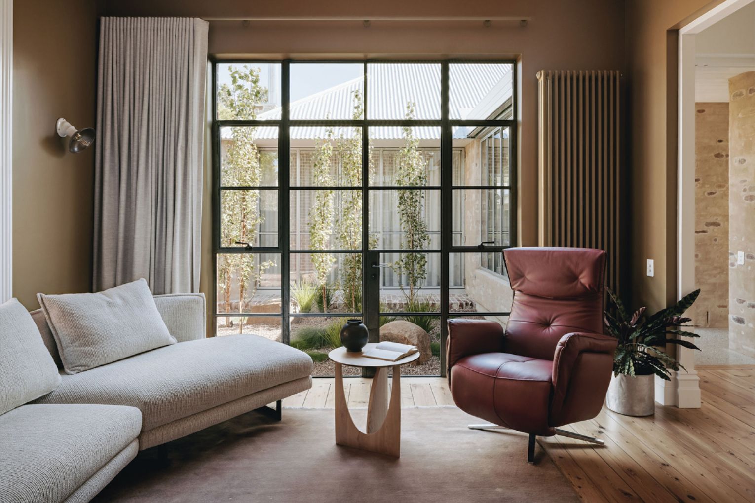 The Lego and whiskey room looks out to a central courtyard, ushering in greenery and light.