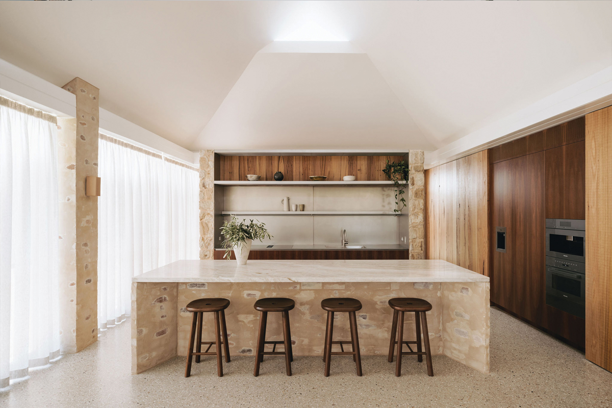 The kitchen's splashback can slide open to create a servery window through to the butler's kitchen.