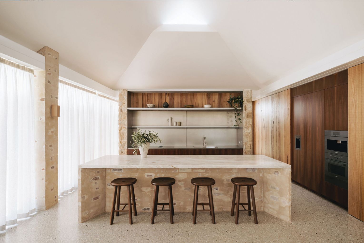 The kitchen's splashback can slide open to create a servery window through to the butler's kitchen.
