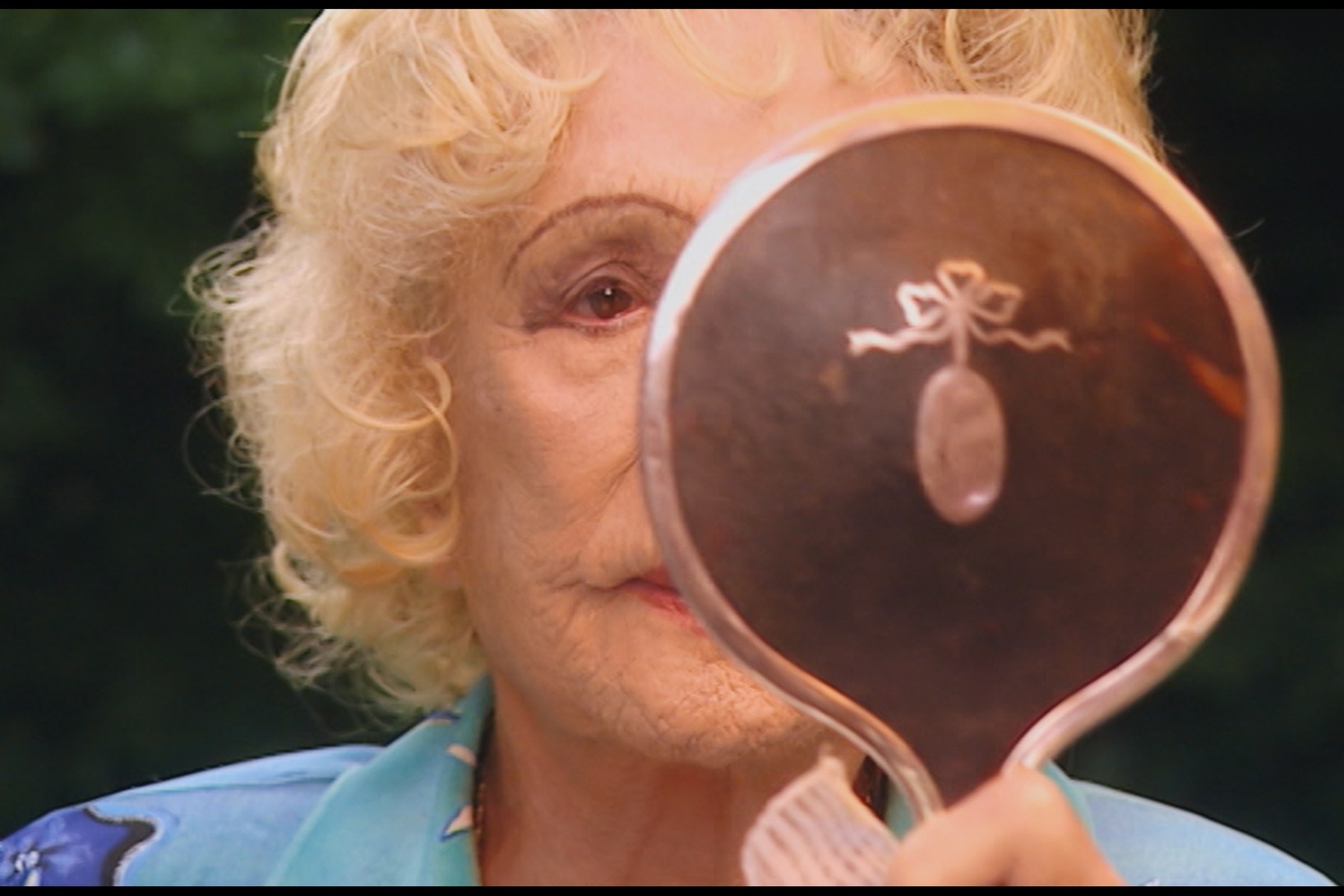 Leni Riefenstahl as an older woman checking her appearance for the recording of a documentary in 1999.