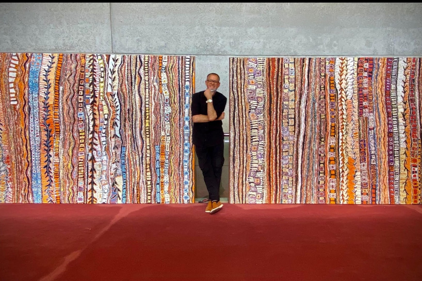 David Hinchliffe at QPAC with two paintings he commissioned from artist Paul
Andy (Pitjantjatjara).