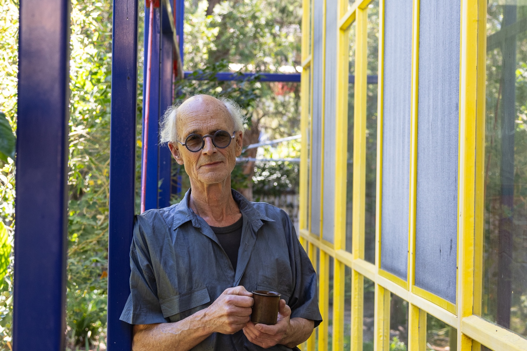“I think he makes things in a deeply considered way". Frank Bauer drinking one of the dozen daily cups of coffee that fuel his work. Photo: Sia Duff / Supplied
