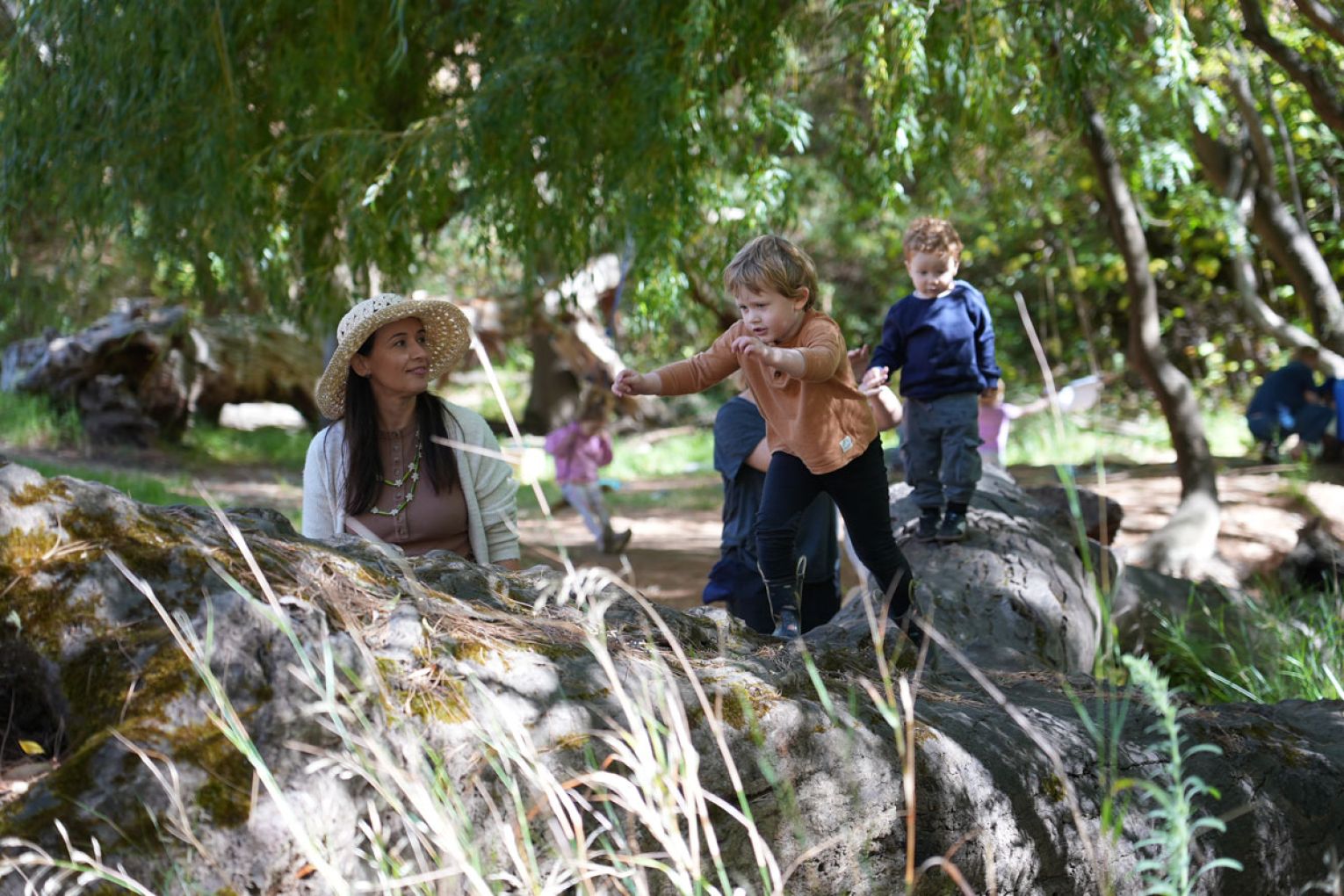 The program also includes nature exploration, as Anders and Teddy balance along a large fallen tree trunk, while Indigo climbs the tree, too.