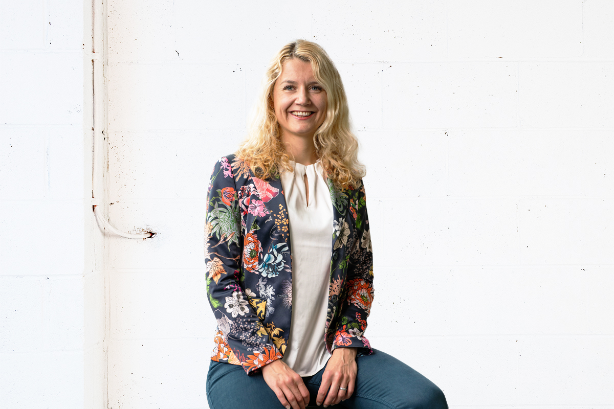 Katharina Richter sitting on a stool in a white room