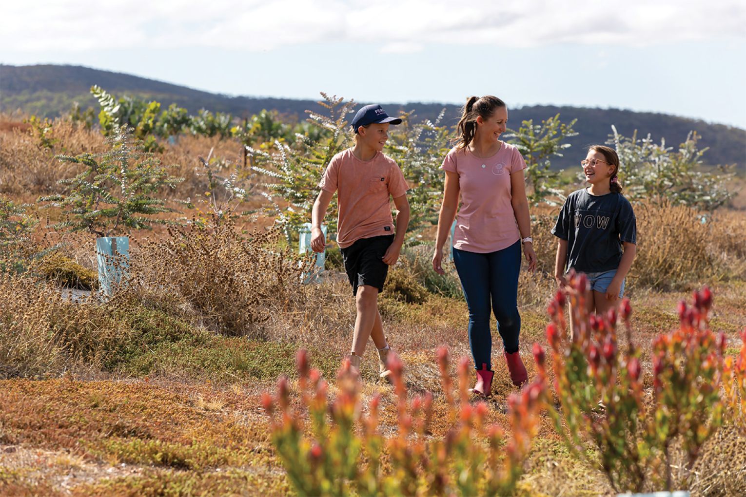 Chase, Jasmin and Bella roam the rows of flowers on their farm, just outside of Cowell on the Eyre Peninsula.