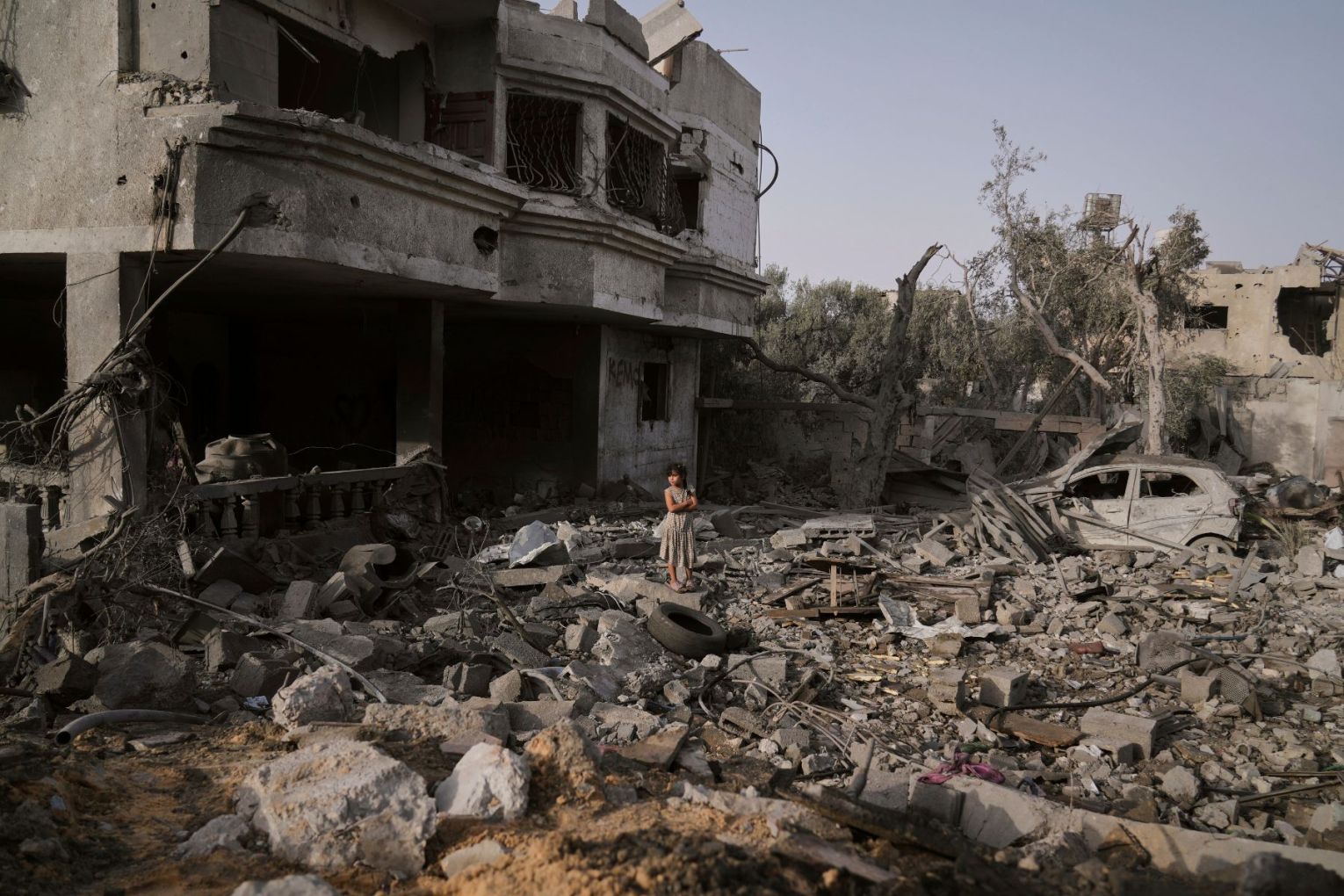 A Palestinian girl stands atop the rubble of the Al-Aimawi family's home that was destroyed by Israeli airstrikes in Al-Zawaideh, Gaza Strip, Tuesday, July 1, 2025. Photo: AP/Abdel Kareem Hana.