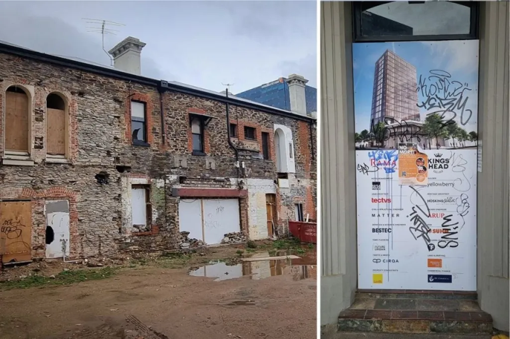 The rear of the King's Head Hotel and a signboard of the proposed development covered in graffiti. Photo: Thomas Kelsall/InDaily