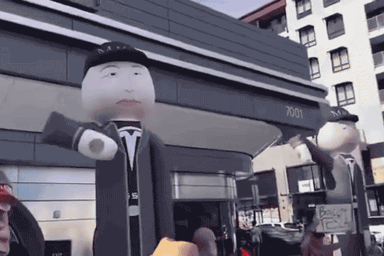Protesters with inflatable Musks demonstrated outside the diner. Photo: x
