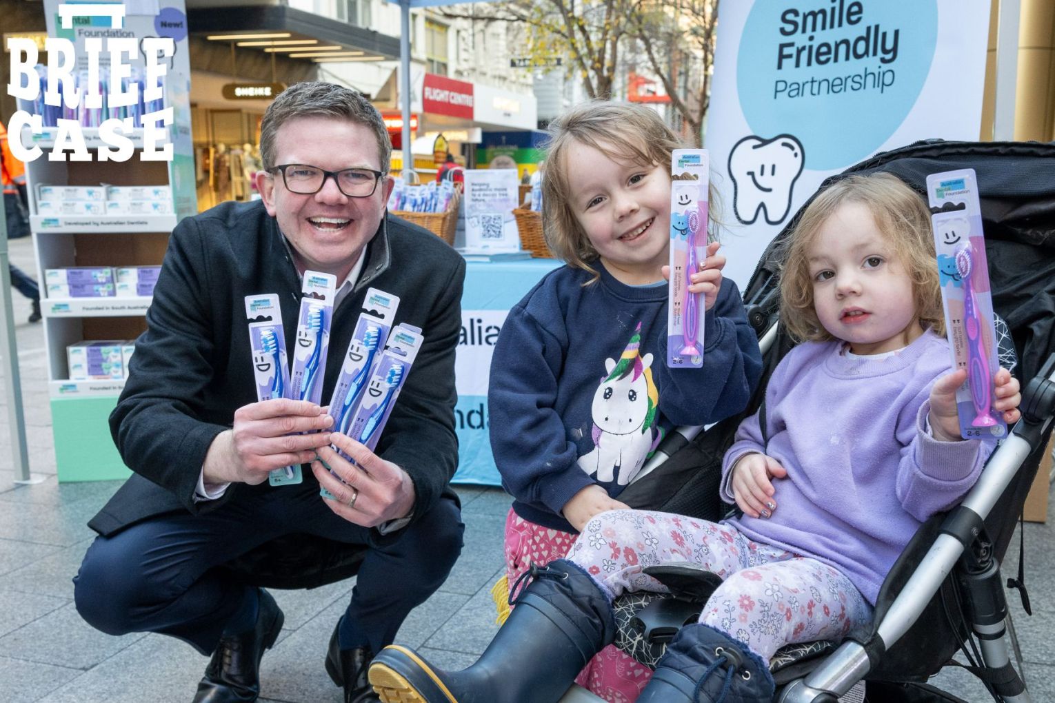 Last week, the Foundation and DCP donated 4800 tubes of toothpaste to children for 'Brush for Good' day. SA Health Minister Chris Picton poses with Rosie and Isla. Photo: Australian Dental Foundation