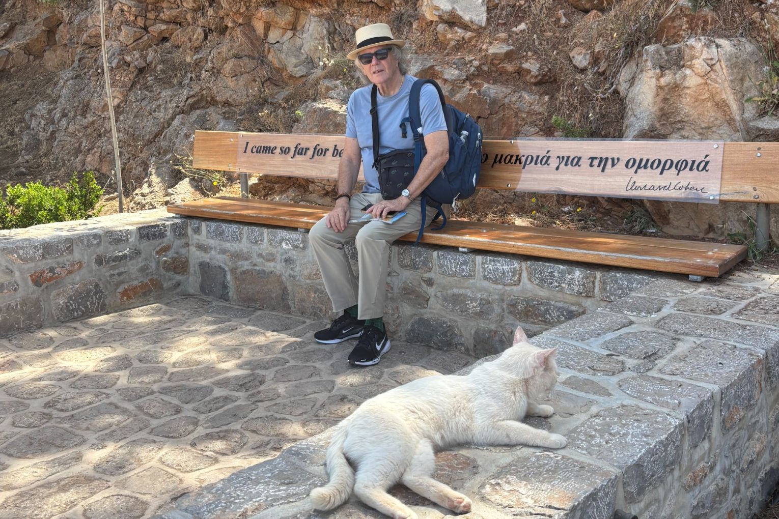Phil Brown thinking of Leonard Cohen while sitting on Cohen's memorial bench on the Greek island of Hydra.