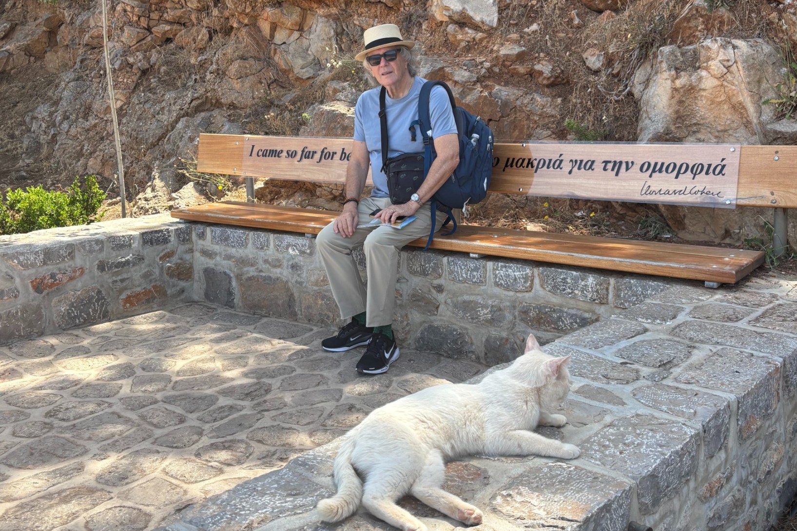 Phil Brown thinking of Leonard Cohen while sitting on Cohen's memorial bench on the Greek island of Hydra.