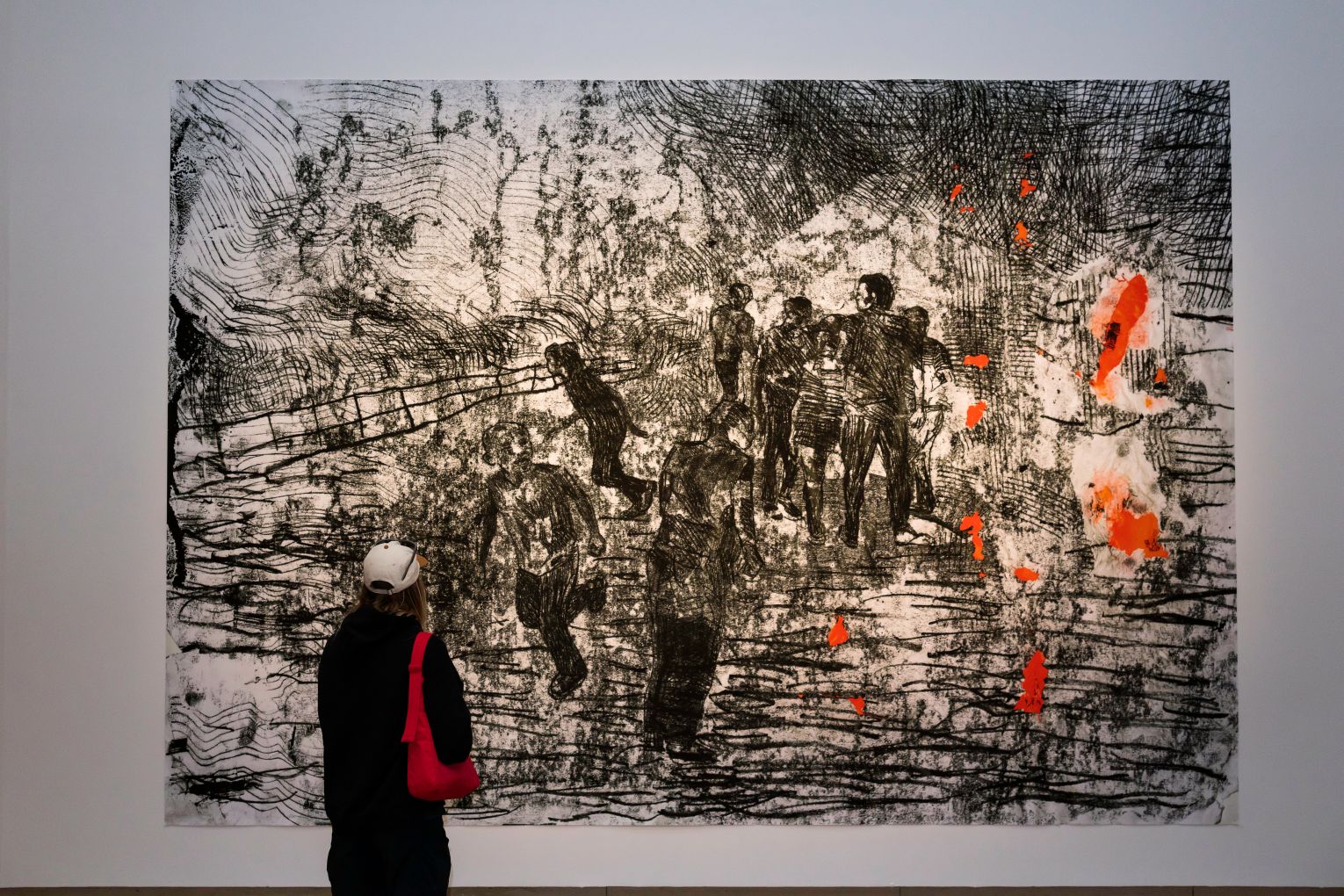 A gallery goer is transfixed by one of the works in Pat Hoffie - I have loved/I love/I will love, now showing at Queensland Art Gallery. Photo: K Bennett Umek © QAGOMA
