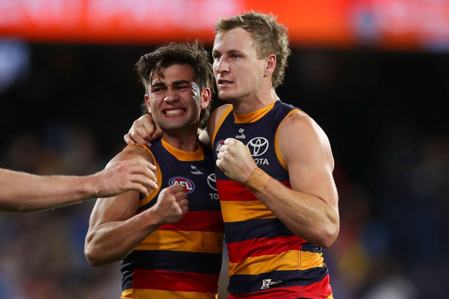 Jordan Dawson of the Crows celebrates victory with team mate Josh Rachele